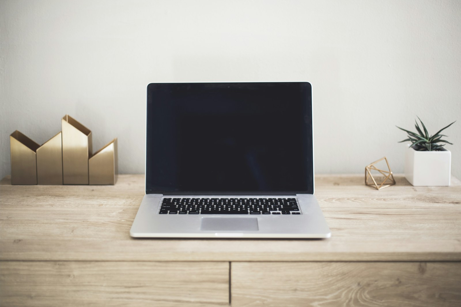 Laptop centered on a clean minimalist wooden desk
